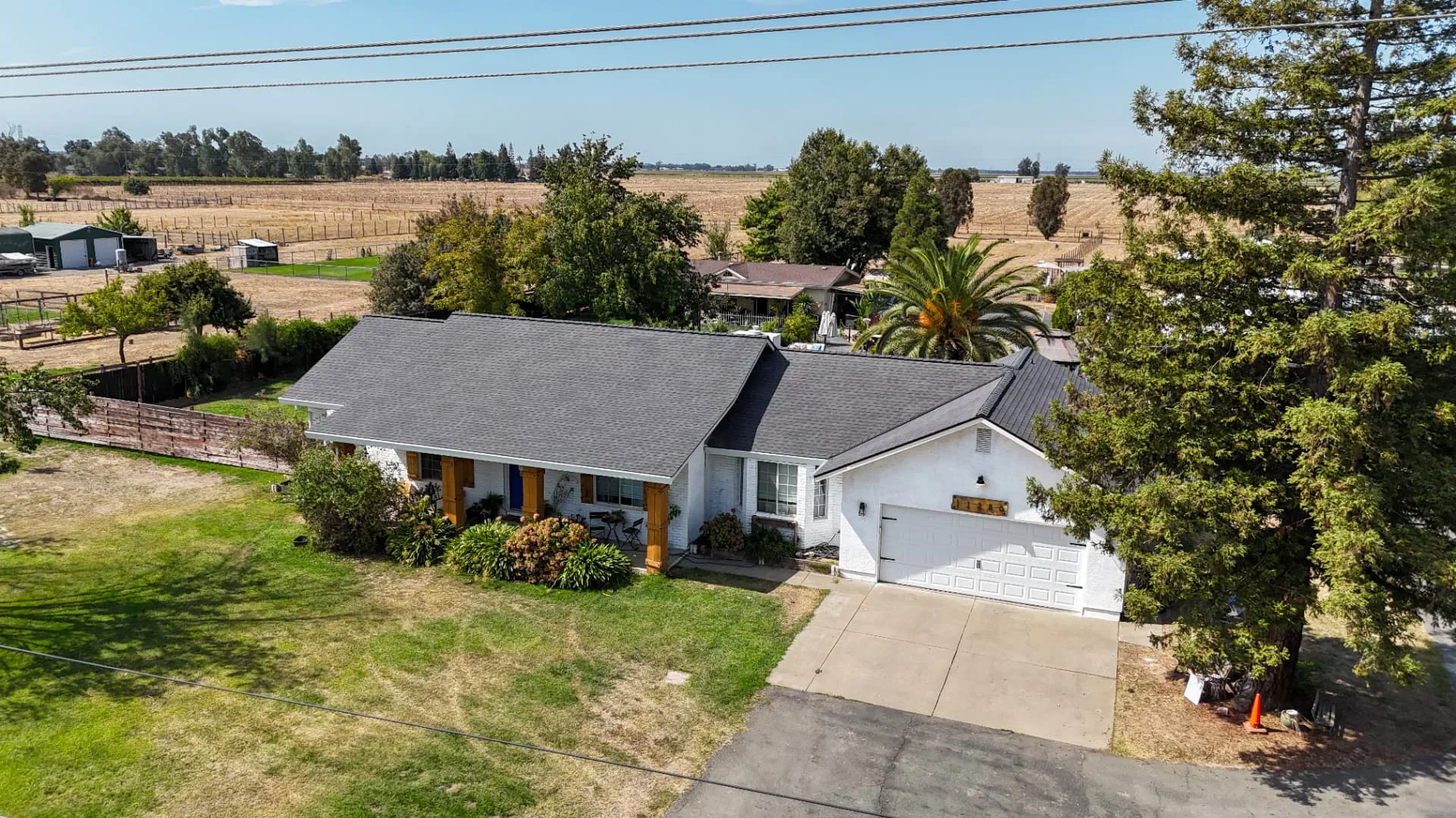 Wide drone view of a completed gray architectural shingle roof on a Sacramento-area home