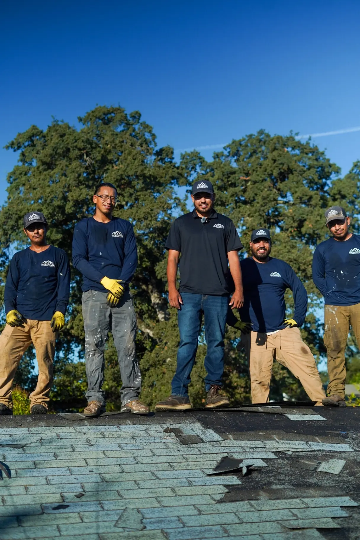 Roofing crew sealing a roof transition detail on a Sacramento property